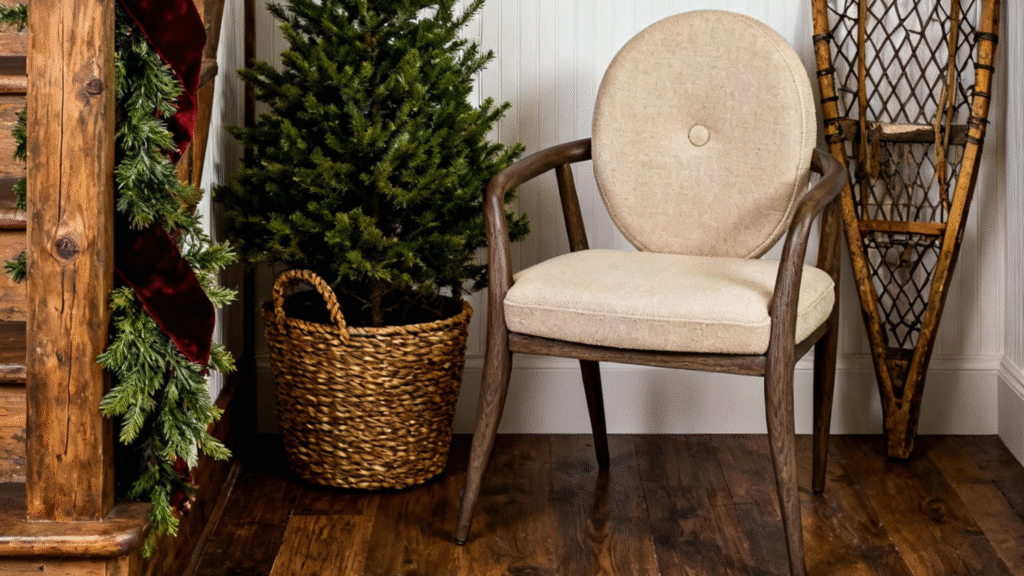 The enveloping Dama Armchair by Sentta with its signature round backrest, placed next to a Christmas tree in a cozy, holiday-ready corner.
